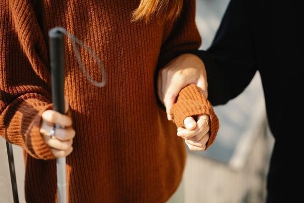 blind person’s rights in Israel - Blind woman holding white cane with guide